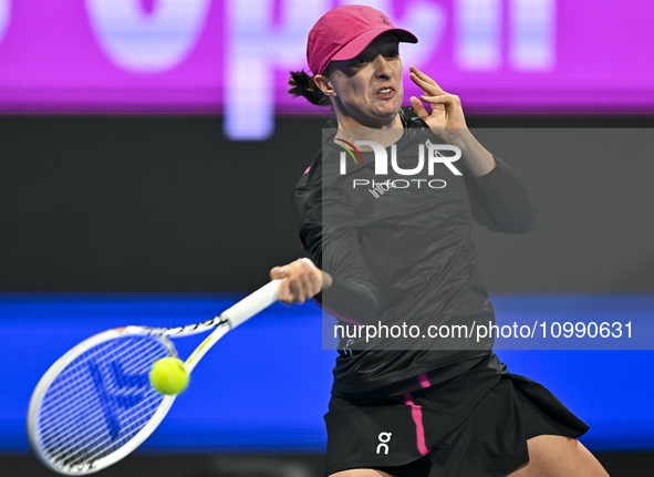 Iga Swiatek of Poland is playing in her second-round match against Sorana Cirstea of Romania at the WTA 1000-Qatar TotalEnergies Open tennis...