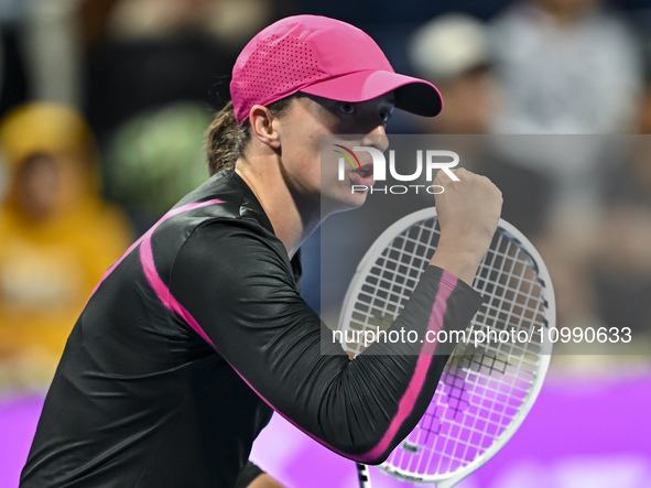 Iga Swiatek of Poland is reacting during her second-round match against Sorana Cirstea of Romania at the WTA 1000-Qatar TotalEnergies Open t...