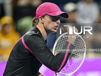 Iga Swiatek of Poland is reacting during her second-round match against Sorana Cirstea of Romania at the WTA 1000-Qatar TotalEnergies Open t...