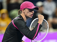 Iga Swiatek of Poland is reacting during her second-round match against Sorana Cirstea of Romania at the WTA 1000-Qatar TotalEnergies Open t...