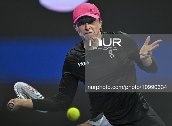 Iga Swiatek of Poland is playing in her second-round match against Sorana Cirstea of Romania at the WTA 1000-Qatar TotalEnergies Open tennis...