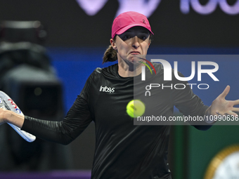 Iga Swiatek of Poland is playing in her second-round match against Sorana Cirstea of Romania at the WTA 1000-Qatar TotalEnergies Open tennis...