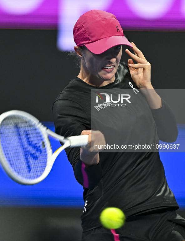 Iga Swiatek of Poland is playing in her second-round match against Sorana Cirstea of Romania at the WTA 1000-Qatar TotalEnergies Open tennis...