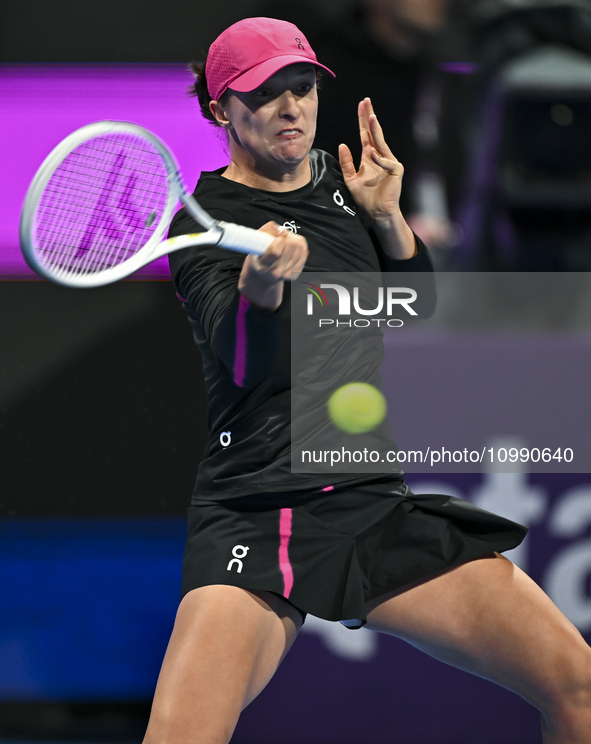 Iga Swiatek of Poland is playing in her second-round match against Sorana Cirstea of Romania at the WTA 1000-Qatar TotalEnergies Open tennis...