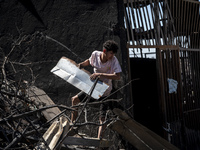 A person is removing debris in Villa Independencia, a place devastated by the mega fire. (