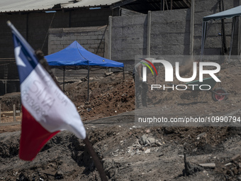 A person is removing debris in Villa Independencia, an area devastated by the mega fire. (