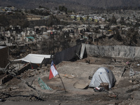 A tent is left in a house affected by the mega forest fire in the Valparaiso region. (