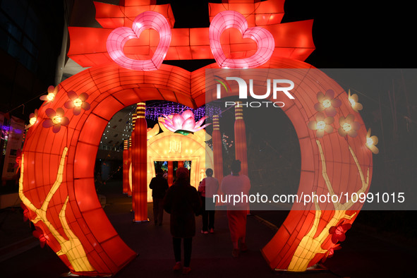 Tourists are enjoying colored lanterns at the Bali Lake Lunar Year Night Tour Cultural Festival in Jiujiang, China, on February 12, 2024. 