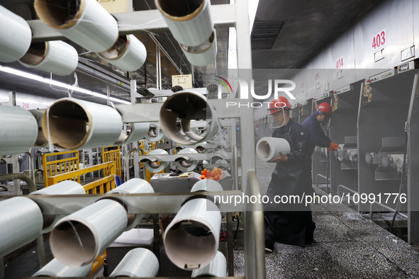 A worker is performing a wire-drawing operation at the production workshop of a glass fiber company in Chongqing, China, on February 11, 202...