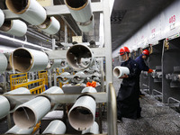 A worker is performing a wire-drawing operation at the production workshop of a glass fiber company in Chongqing, China, on February 11, 202...