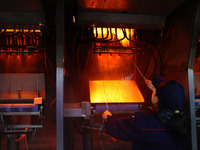 A worker is performing a wire-drawing operation at the production workshop of a glass fiber company in Chongqing, China, on February 11, 202...