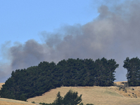 Smoke is rising thickly from a fire in Christchurch, New Zealand, on February 14, 2024. Authorities are declaring a local state of emergency...