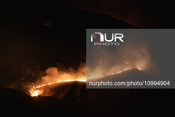 Flames are rising while efforts to extinguish the wildfire that broke out in Port Hills, Christchurch, New Zealand, on February 14, 2024, co...