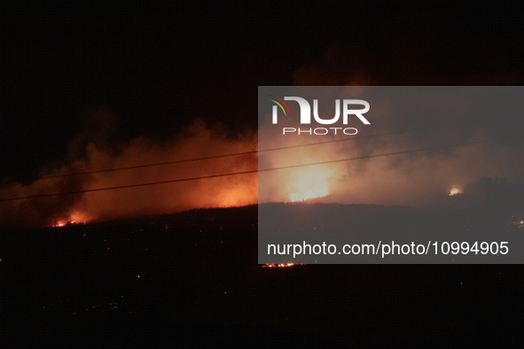 Flames are rising while efforts to extinguish the wildfire that broke out in Port Hills, Christchurch, New Zealand, on February 14, 2024, co...