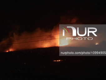 Flames are rising while efforts to extinguish the wildfire that broke out in Port Hills, Christchurch, New Zealand, on February 14, 2024, co...