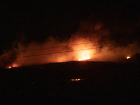 Flames are rising while efforts to extinguish the wildfire that broke out in Port Hills, Christchurch, New Zealand, on February 14, 2024, co...