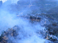 Smoke is rising from a vegetation fire in Port Hills, Canterbury region, New Zealand, on February 15, 2024. (