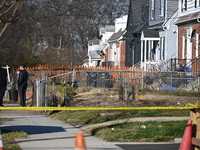 Investigators are searching a residence and gathering evidence on Hanna Place Southeast in Washington, DC, United States, on February 15, 20...