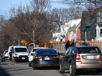 Investigators are searching a residence and gathering evidence on Hanna Place Southeast in Washington, DC, United States, on February 15, 20...