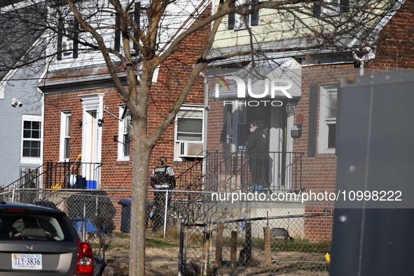 Investigators are searching a residence and gathering evidence on Hanna Place Southeast in Washington, DC, United States, on February 15, 20...