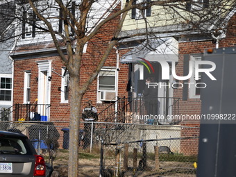 Investigators are searching a residence and gathering evidence on Hanna Place Southeast in Washington, DC, United States, on February 15, 20...