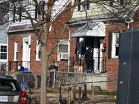 Investigators are searching a residence and gathering evidence on Hanna Place Southeast in Washington, DC, United States, on February 15, 20...