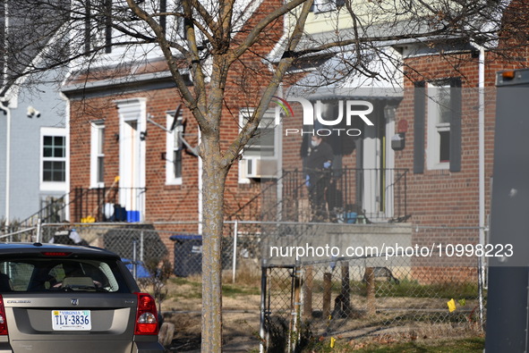 Investigators are searching a residence and gathering evidence on Hanna Place Southeast in Washington, DC, United States, on February 15, 20...