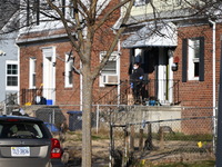 Investigators are searching a residence and gathering evidence on Hanna Place Southeast in Washington, DC, United States, on February 15, 20...