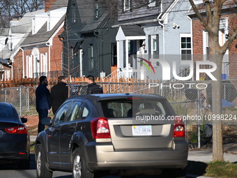 Investigators are searching a residence and gathering evidence on Hanna Place Southeast in Washington, DC, United States, on February 15, 20...