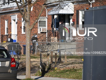 Investigators are searching a residence and gathering evidence on Hanna Place Southeast in Washington, DC, United States, on February 15, 20...