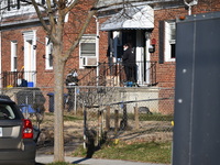 Investigators are searching a residence and gathering evidence on Hanna Place Southeast in Washington, DC, United States, on February 15, 20...