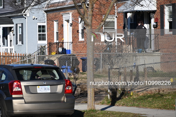 Investigators are searching a residence and gathering evidence on Hanna Place Southeast in Washington, DC, United States, on February 15, 20...