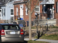 Investigators are searching a residence and gathering evidence on Hanna Place Southeast in Washington, DC, United States, on February 15, 20...