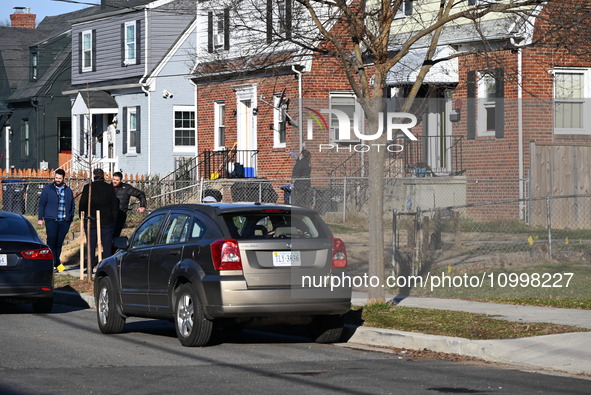 Investigators are searching a residence and gathering evidence on Hanna Place Southeast in Washington, DC, United States, on February 15, 20...