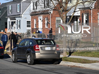 Investigators are searching a residence and gathering evidence on Hanna Place Southeast in Washington, DC, United States, on February 15, 20...