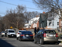 Investigators are searching a residence and gathering evidence on Hanna Place Southeast in Washington, DC, United States, on February 15, 20...