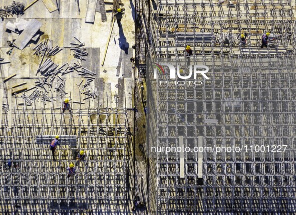 Workers are reinforcing the Yundong Gate at the construction site for the Subei Irrigation Canal in Huai'an, China, on February 16, 2024. 