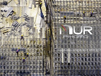 Workers are reinforcing the Yundong Gate at the construction site for the Subei Irrigation Canal in Huai'an, China, on February 16, 2024. (