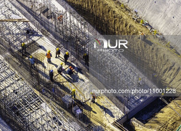 Workers are reinforcing the Yundong Gate at the construction site for the Subei Irrigation Canal in Huai'an, China, on February 16, 2024. 