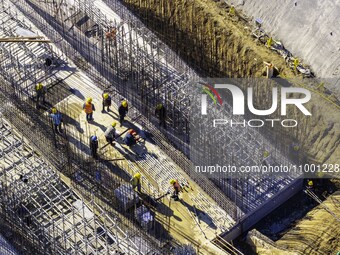 Workers are reinforcing the Yundong Gate at the construction site for the Subei Irrigation Canal in Huai'an, China, on February 16, 2024. (