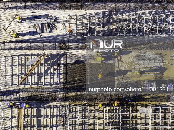 Workers are reinforcing the Yundong Gate at the construction site for the Subei Irrigation Canal in Huai'an, China, on February 16, 2024. 