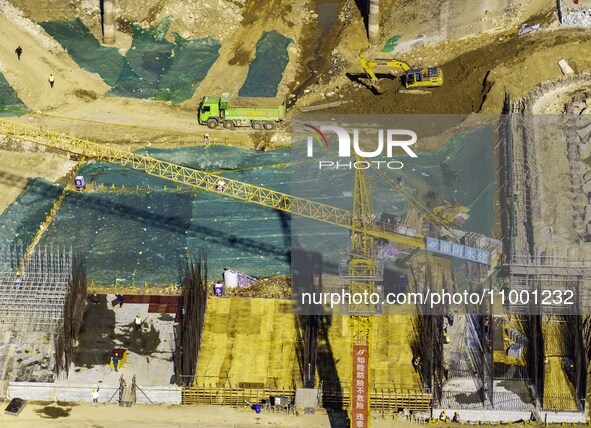 Workers are reinforcing the Yundong Gate at the construction site for the Subei Irrigation Canal in Huai'an, China, on February 16, 2024. 