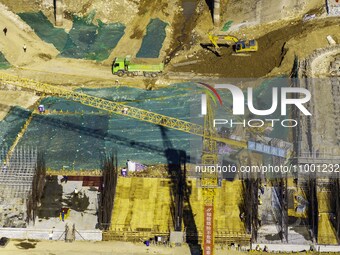 Workers are reinforcing the Yundong Gate at the construction site for the Subei Irrigation Canal in Huai'an, China, on February 16, 2024. (