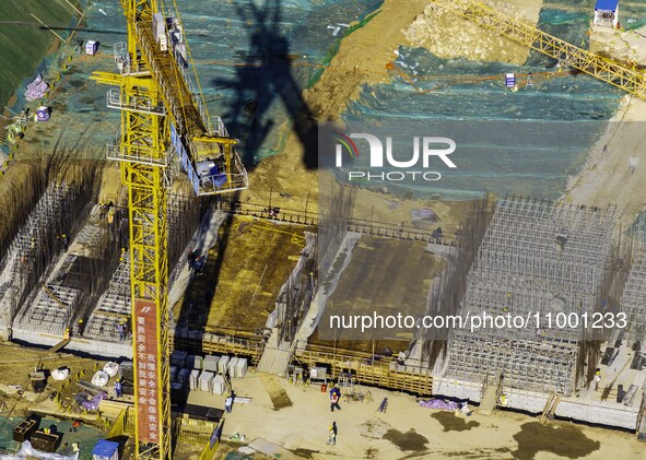 Workers are reinforcing the Yundong Gate at the construction site for the Subei Irrigation Canal in Huai'an, China, on February 16, 2024. 