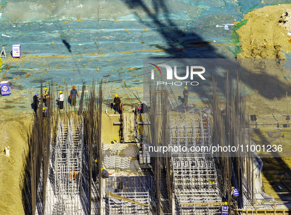 Workers are reinforcing the Yundong Gate at the construction site for the Subei Irrigation Canal in Huai'an, China, on February 16, 2024. 