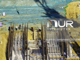 Workers are reinforcing the Yundong Gate at the construction site for the Subei Irrigation Canal in Huai'an, China, on February 16, 2024. (