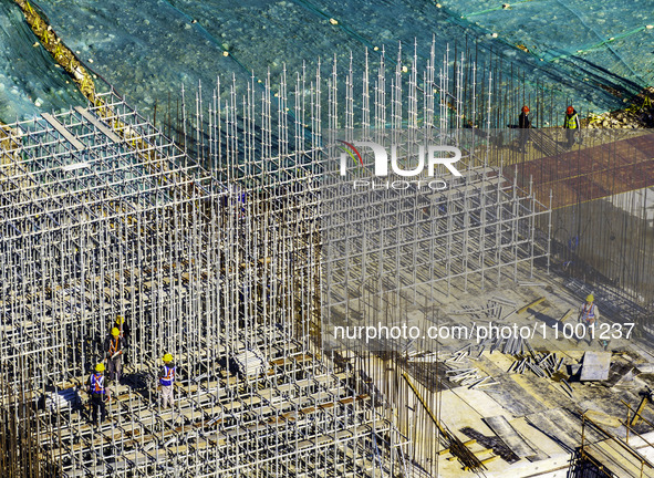 Workers are reinforcing the Yundong Gate at the construction site for the Subei Irrigation Canal in Huai'an, China, on February 16, 2024. 