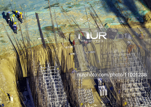 Workers are reinforcing the Yundong Gate at the construction site for the Subei Irrigation Canal in Huai'an, China, on February 16, 2024. 