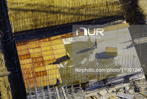 Workers are reinforcing the Yundong Gate at the construction site for the Subei Irrigation Canal in Huai'an, China, on February 16, 2024. 