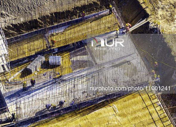 Workers are reinforcing the Yundong Gate at the construction site for the Subei Irrigation Canal in Huai'an, China, on February 16, 2024. 